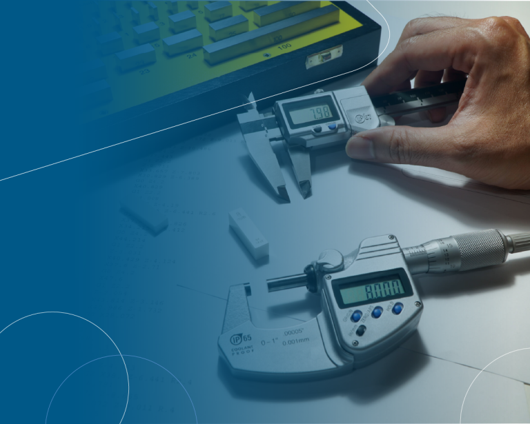 Close-up of hand using digital calipers and micrometer for precision measurement.